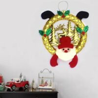 Ascension Christmas wreath featuring a gold circular frame, cutout trees, and a plush Santa face.