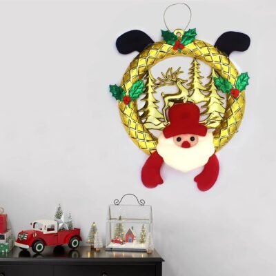 Ascension Christmas wreath featuring a gold circular frame, cutout trees, and a plush Santa face.