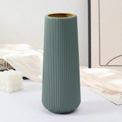 Modern sage green Plastic Flower Pot with vertical ribbed texture on a white table.