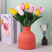 Red Plastic Unbreakable Flower Pot with wavy textured pattern placed on a white tabletop.
