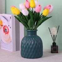 White Plastic Flower Pot with vertical wave texture resting on a wooden table.