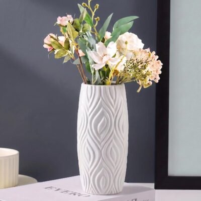 White plastic flower pot with modern wave texture displayed on a wooden table