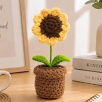 Single Handmade Crochet Sunflower in Pot placed on a wooden table.