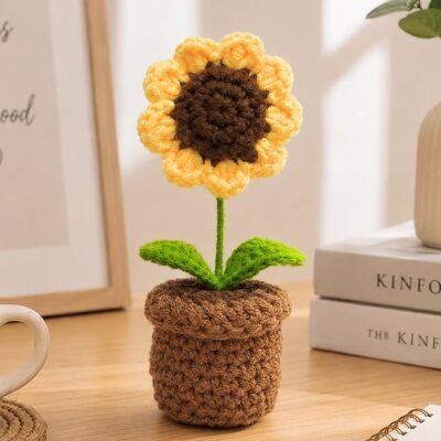 Single Handmade Crochet Sunflower in Pot placed on a wooden table.