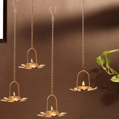 Golden flower wall hanging tealight candle holders suspended on chains with lit tea lights