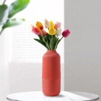 Red Plastic Flower Pot with vertical ribbed fluting on top and a textured base.
