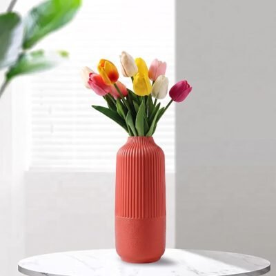 Red Plastic Flower Pot with vertical ribbed fluting on top and a textured base.