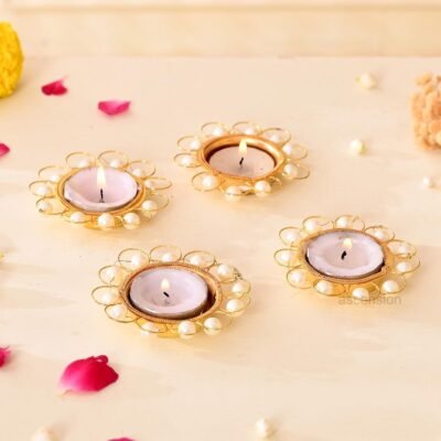 Golden metal wire loop tealight candle holders with pearl beads and lit candles
