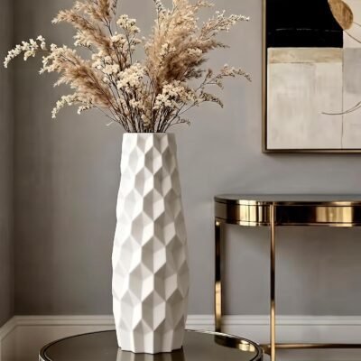 White plastic flower pot with modern geometric 3D diamond origami pattern on a wooden tabletop