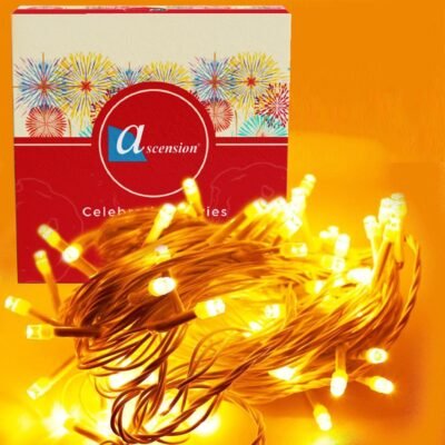 Yellow fairy string lights bundled next to decorative packaging