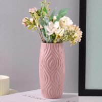 Pink Plastic Flower Pot with 3D geometric wave pattern resting on a white table.
