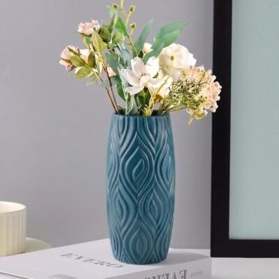 Blue Plastic Flower Pot with 3D geometric wave pattern resting on a white table.