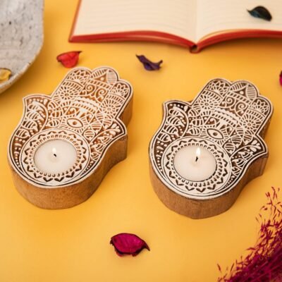 Hand carved Hamsa hand wooden tealight holders with white painted details and lit candles