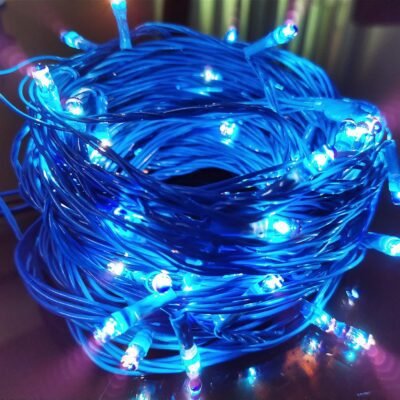 Bundled blue fairy string lights glowing brightly on a table surface
