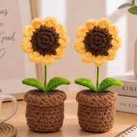 Pack of 2 Handmade Crochet Sunflower in Pot placed side by side on a wooden table.