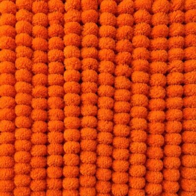 Vertical strings of 10 Pcs Orange Handmade Artificial Marigold Flowers forming a dense wall backdrop.