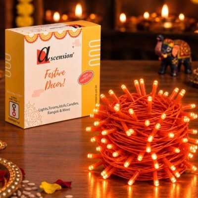Ascension brand yellow orange LED pixel string light bundle next to product packaging box on a festive table setting