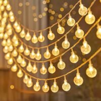 Warm white crystal bubble globe string lights glowing in elegant cascading strands