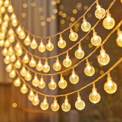 Warm white crystal bubble globe string lights glowing in elegant cascading strands