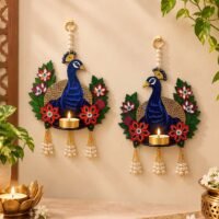 Decorative blue peacock wall hanging diya holder with floral details and pearl tassels for Diwali decoration