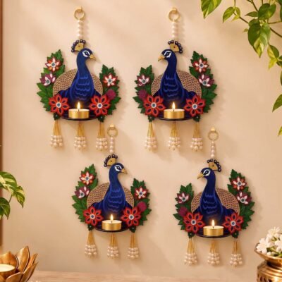 Decorative blue peacock wall hanging diya holder with floral details and pearl tassels for Diwali decoration