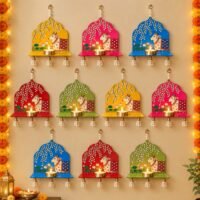 Colorful cow wall hanging diya holders with pearl tassels and diyas for Diwali and pooja decoration