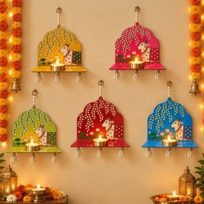 Colorful cow wall hanging diya holders with pearl tassels and diyas for Diwali and pooja decoration