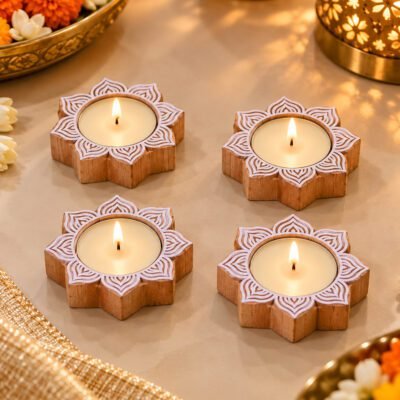 Handcrafted Wooden Lotus candle base set of 4 with lit tealights on a marble surface.