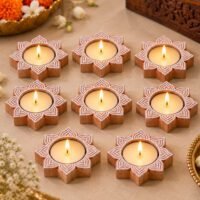 Handcrafted wooden Lotus Tealight base set of 8 with lit candles on a marble surface.