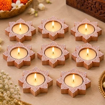 Handcrafted wooden Lotus Tealight base set of 8 with lit candles on a marble surface.