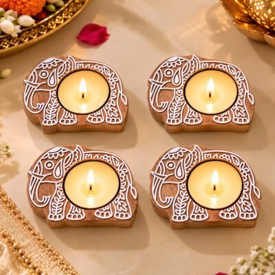 Handcrafted Wooden Elephant candle holder set of 4 with lit tealights on a marble surface .