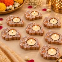 Handcrafted wooden Elephant Tealight base set of 8 with lit candles on a marble surface.