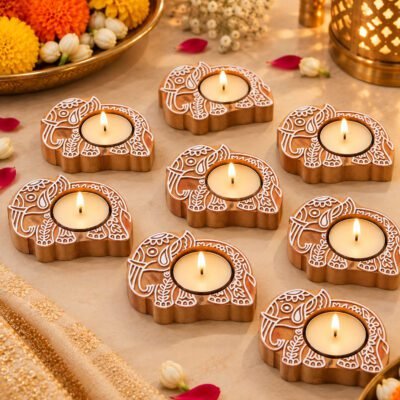 Handcrafted wooden Elephant Tealight base set of 8 with lit candles on a marble surface.