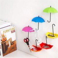 Colorful umbrella-shaped wall mount hooks holding scissors, earphones, and small desk accessories