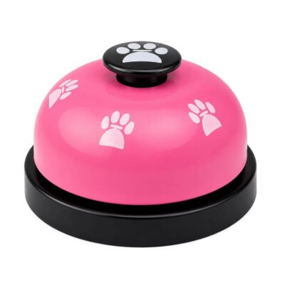 Pink dog training call bell with white paw prints on a black non-slip base.