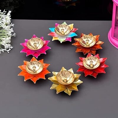 Pack of six colorful lotus flower brass diyas arranged on a grey surface