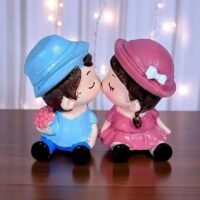 Ascension cute couple showpiece with magnetic lips featuring a boy in blue and girl in pink kissing.