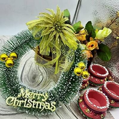 Ascension green holiday wreath with a gold bow, baubles, and a Merry Christmas sign.