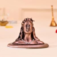 Copper finish Lord Adiyogi Shiva bust statue featuring shiny stone necklace on oval base