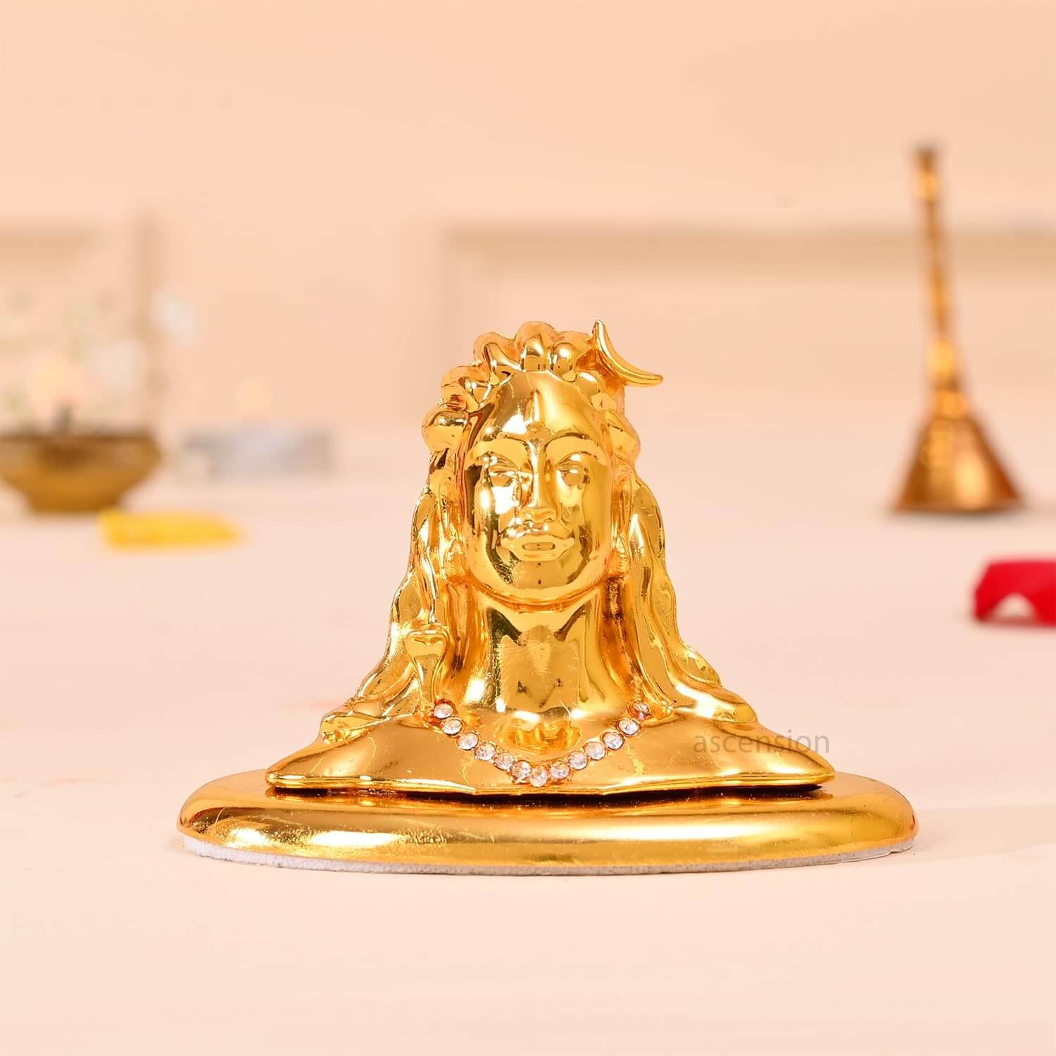 Golden Adiyogi Shiva Idol for Car Dashboard placed on smooth surface
