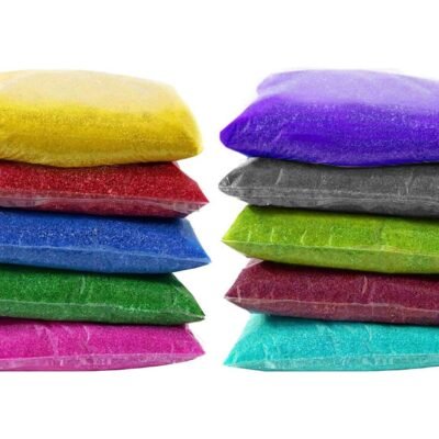 Ascension Rangoli Powder Color Pouches stacked in two columns of 80g clear pouches with 10 vibrant colors.