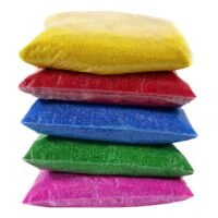 Ascension Rangoli Color Powder Packets stacked in yellow, red, blue, green, and pink 80g clear pouches.