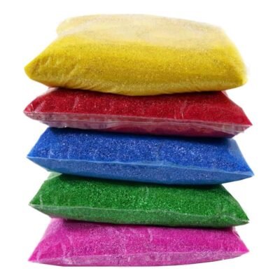 Ascension Rangoli Color Powder Packets stacked in yellow, red, blue, green, and pink 80g clear pouches.