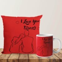 Red couple throw pillow and matching ceramic mug printed with "I Love You Forever" line art illustration on a wooden table.