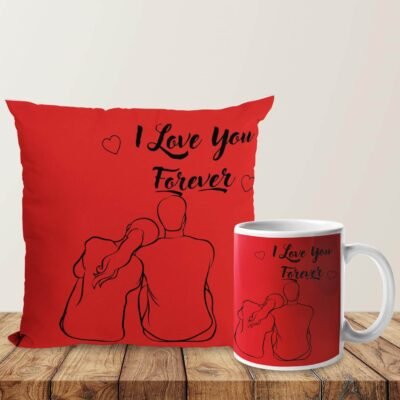 Red couple throw pillow and matching ceramic mug printed with "I Love You Forever" line art illustration on a wooden table.