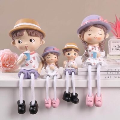 Ascension 4 piece family dangling leg showpiece featuring four figures in hats sipping drinks sitting on a white ledge.
