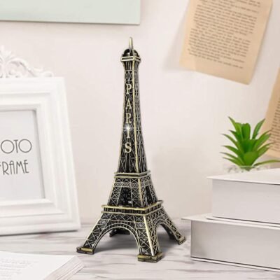 Metallic bronze Eiffel Tower replica statue with Paris inscription standing on a desk