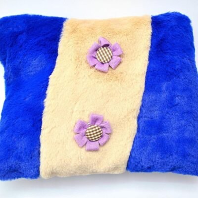 Ascension plush hot water bag with soft blue and beige fur cover and purple flower appliques.