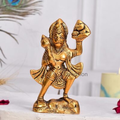 Brass Hanuman statue carrying Sanjeevani mountain and gada mace on a white table