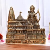 Golden brass Ayodhya Ram Mandir statue featuring Lord Ram with bow and Jai Shree Ram inscription on wooden surface